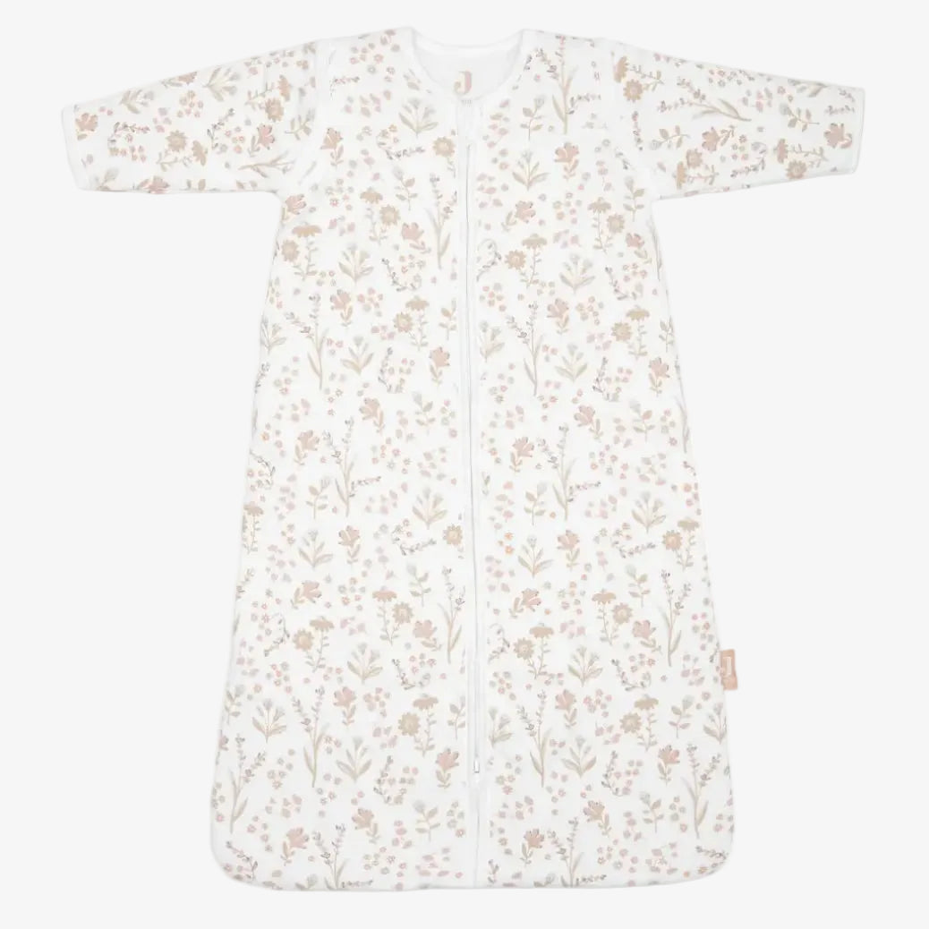 A long-sleeve baby sleep sack with a front zipper, featuring an all-over delicate floral and botanical pattern in soft tan and light brown on a white background.