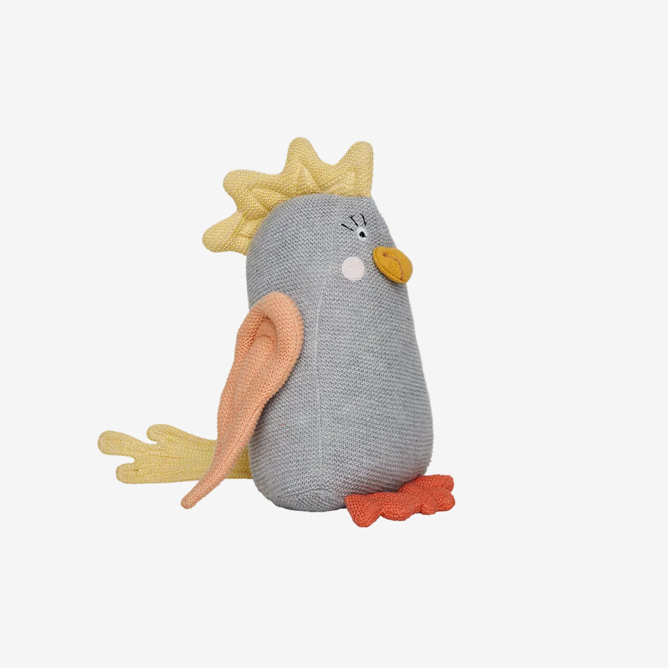 Plush toy resembling a bird with a gray body and yellow crest on a white background