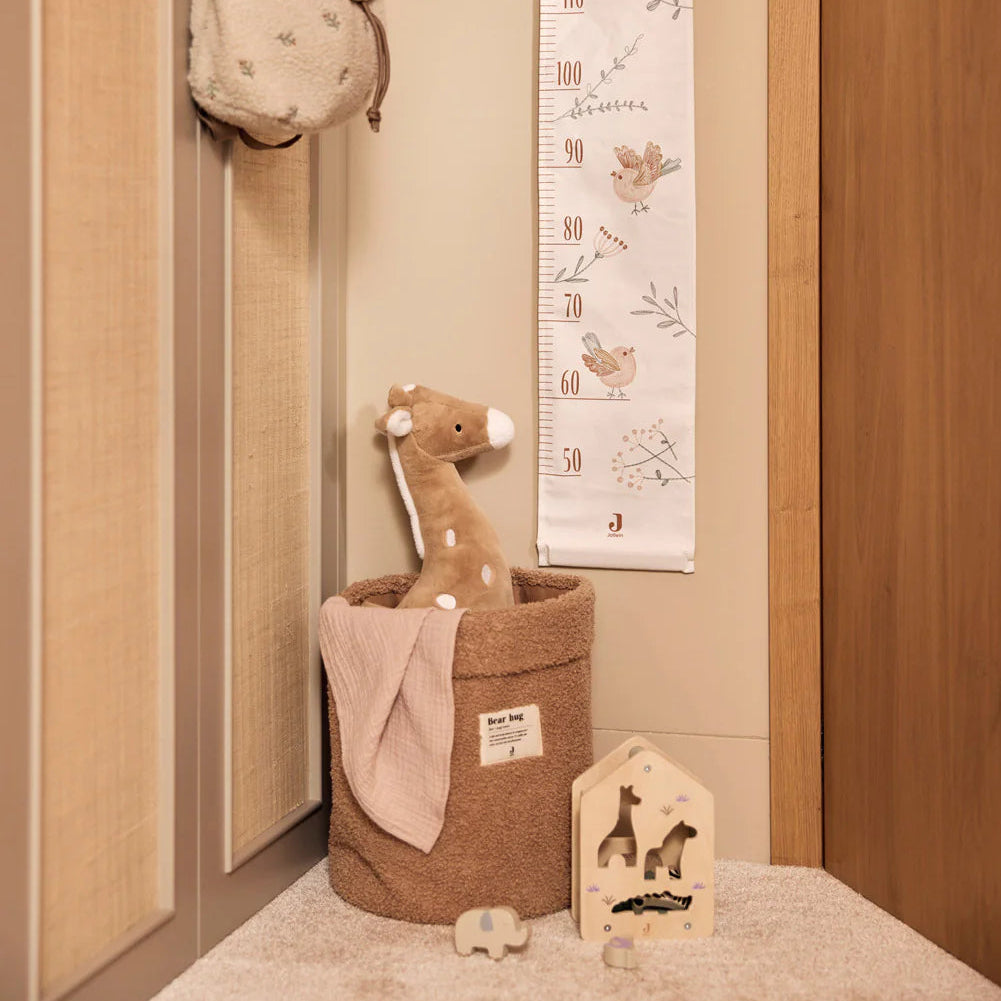 Wooden Shape Sorter - Jungle Jambo on a beige carpet with brown boucle basket and toy giraffe