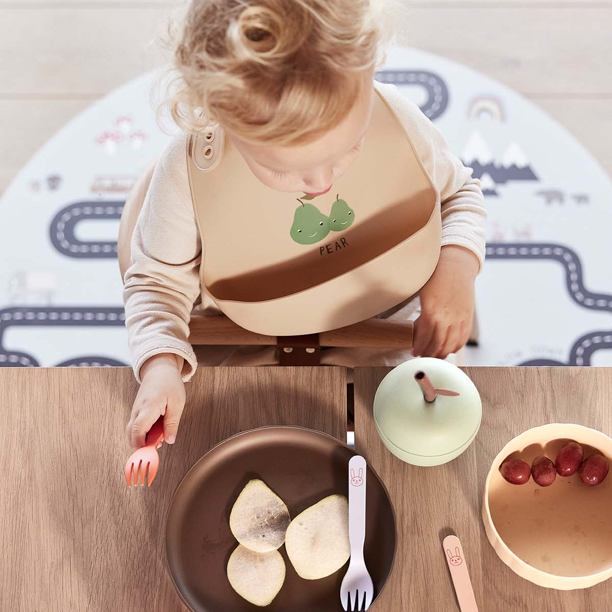 little otja green apple on dining table used by a kid
