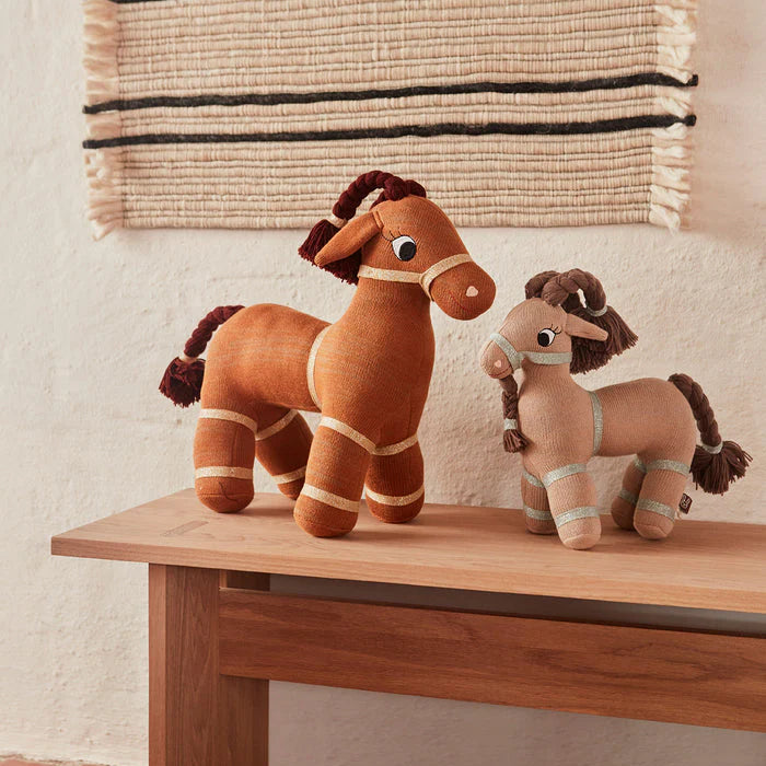 little otja taffy goat displayed with baby goat on the table