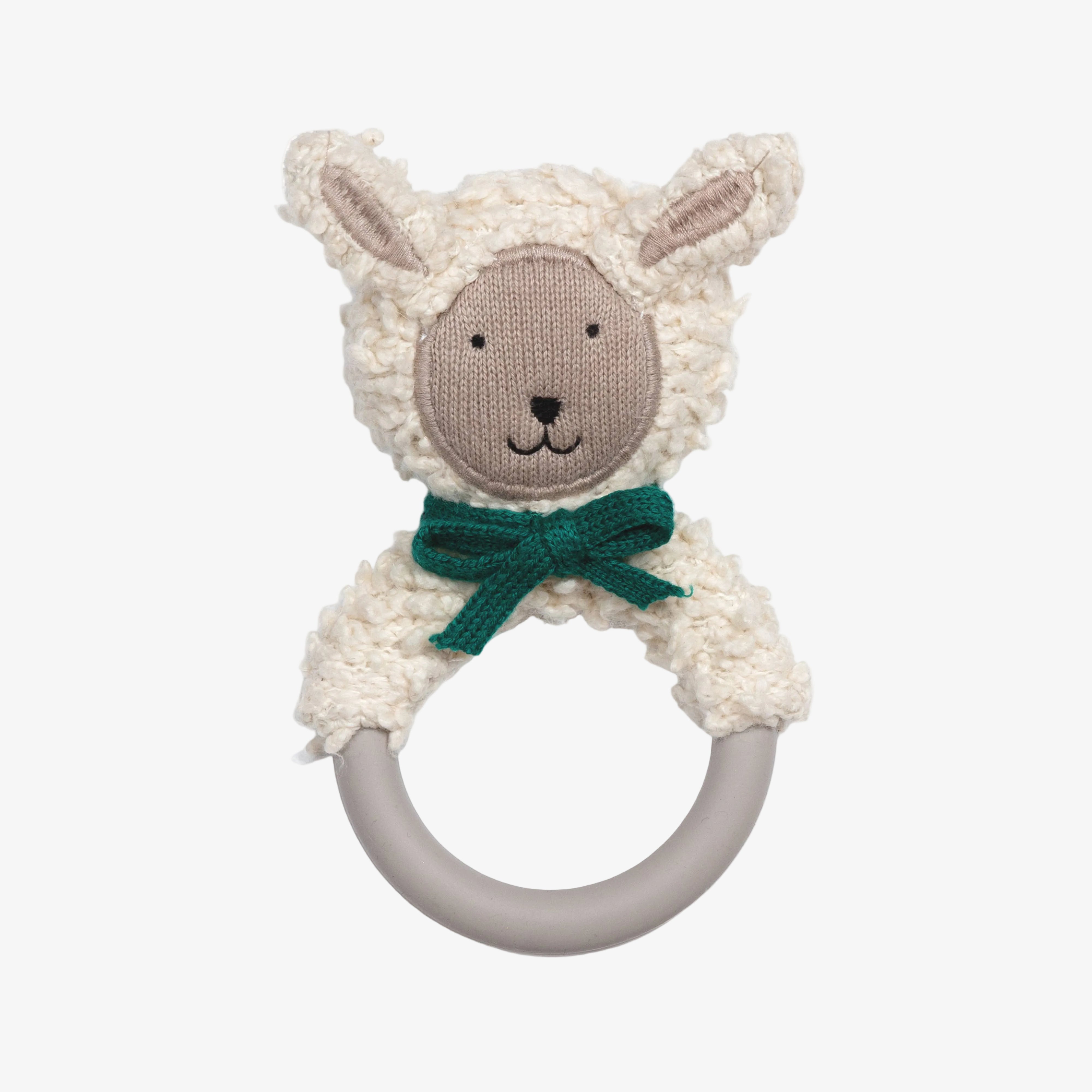 A plush sheep rattle toy with a cream-colored textured fleece body, a beige embroidered face, a dark green bow, and a gray silicone ring handle, shown on a plain white background.