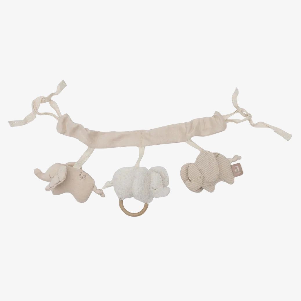 Baby mobile with three plush animals on a branch against a white background