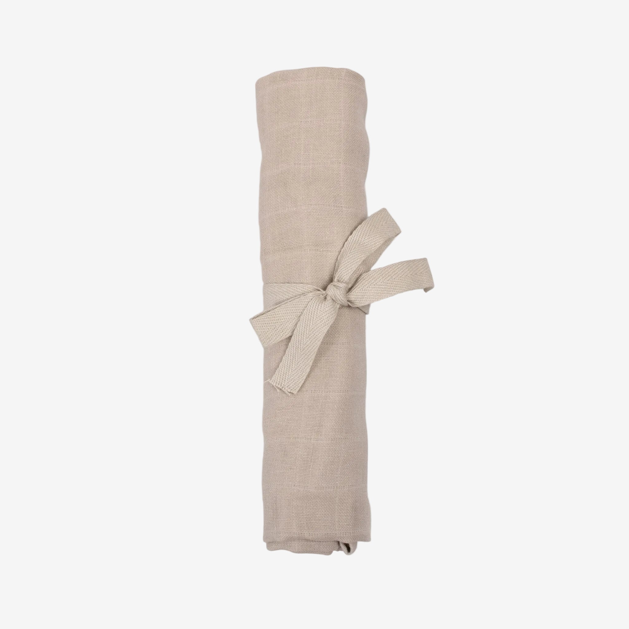 Rolled beige fabric with a bow on a white background