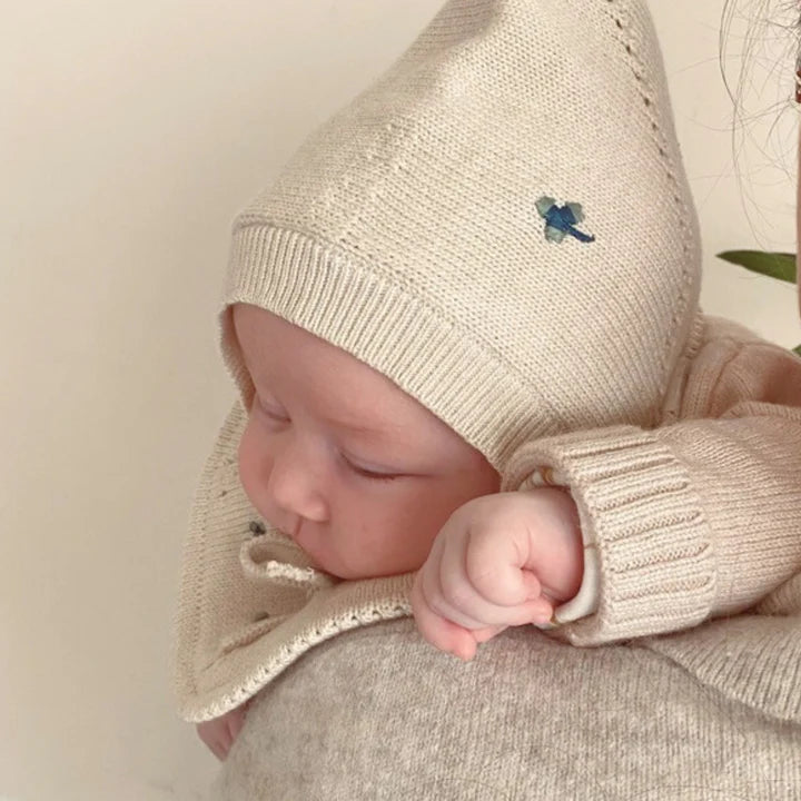 little otja bonnet clover on cream on a baby