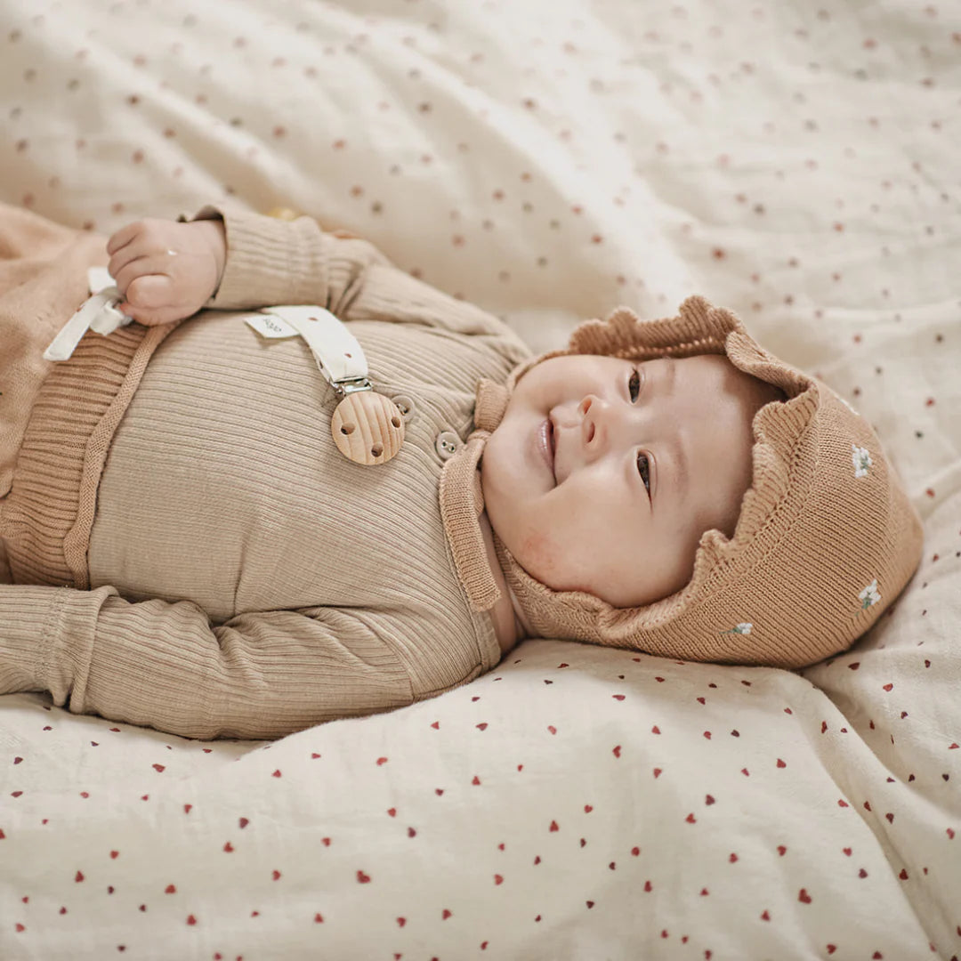 little otja Bonnet Lilly Flower on Nude on a baby