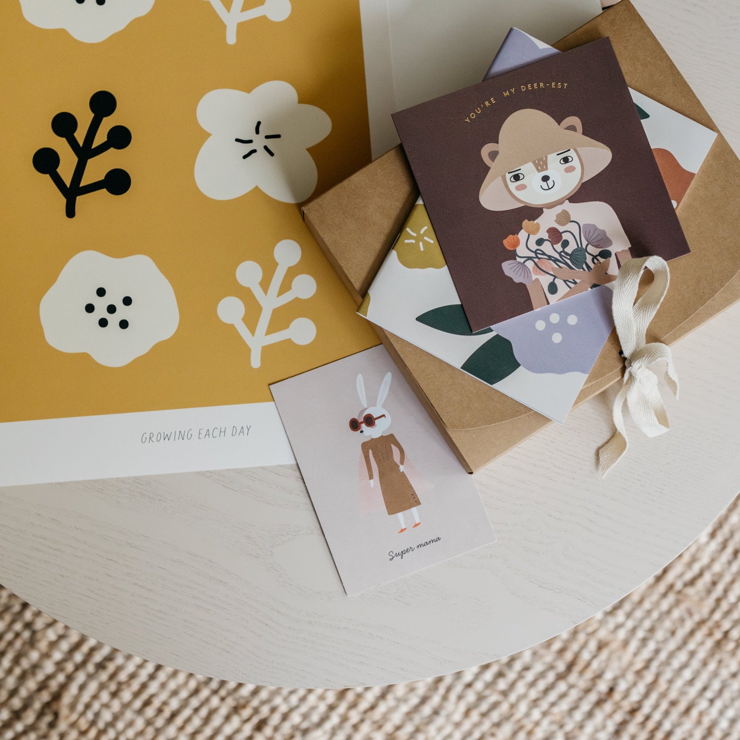 Set of greeting cards with floral and animal designs on a round surface.