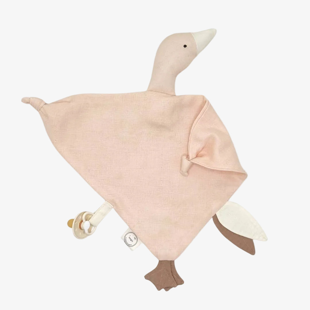 A soft fabric duck security blanket with a pale pink body, cream beak and inner tail, and brown feet, shown on a plain white background.