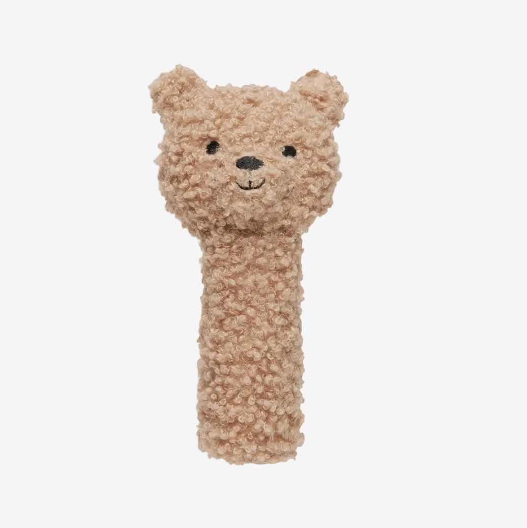 Textured bear-shaped hand rattle on a white background