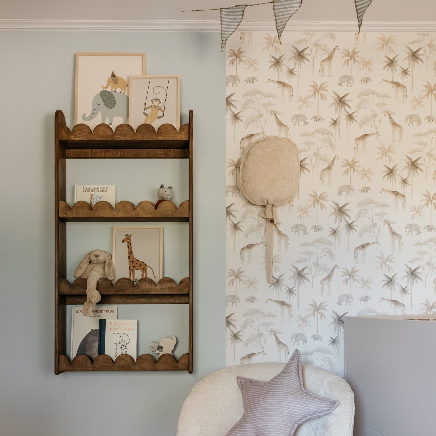Nursery room with a round white chair, decorative wall, and shelves with toys.