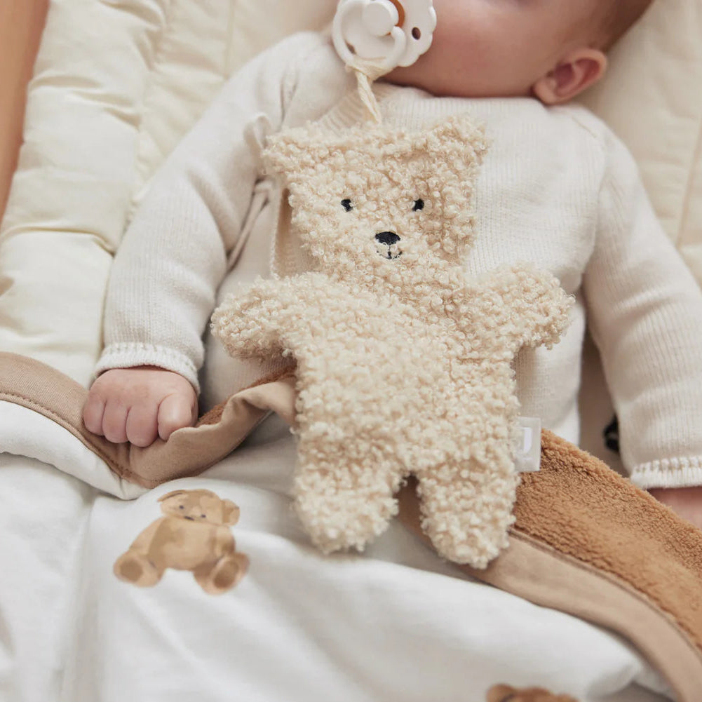 little otja pacifier teddy bear cloth with a newborn
