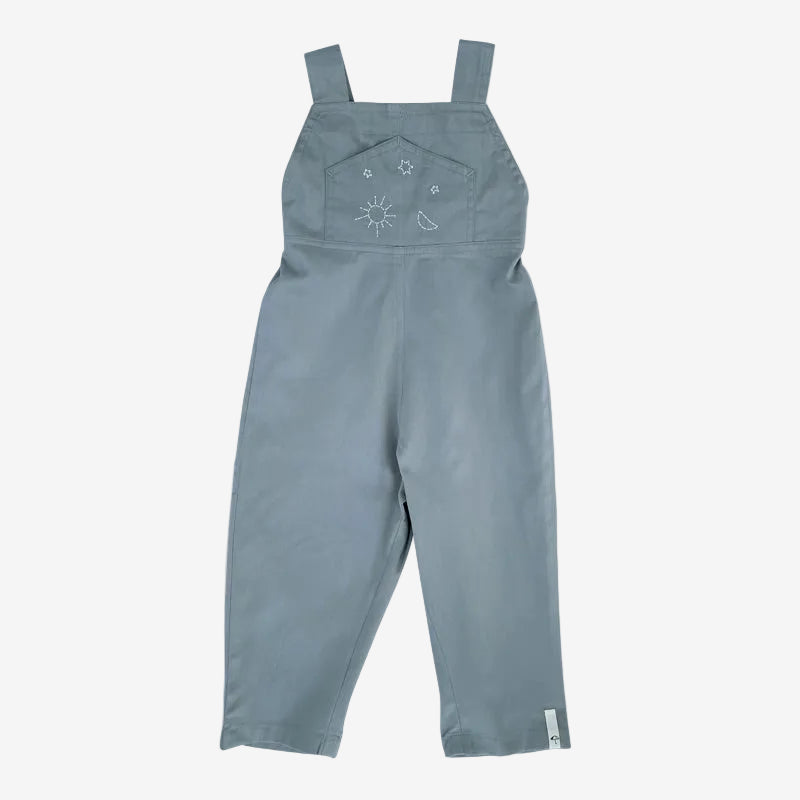 Blue overalls with embroidered design on a white background
